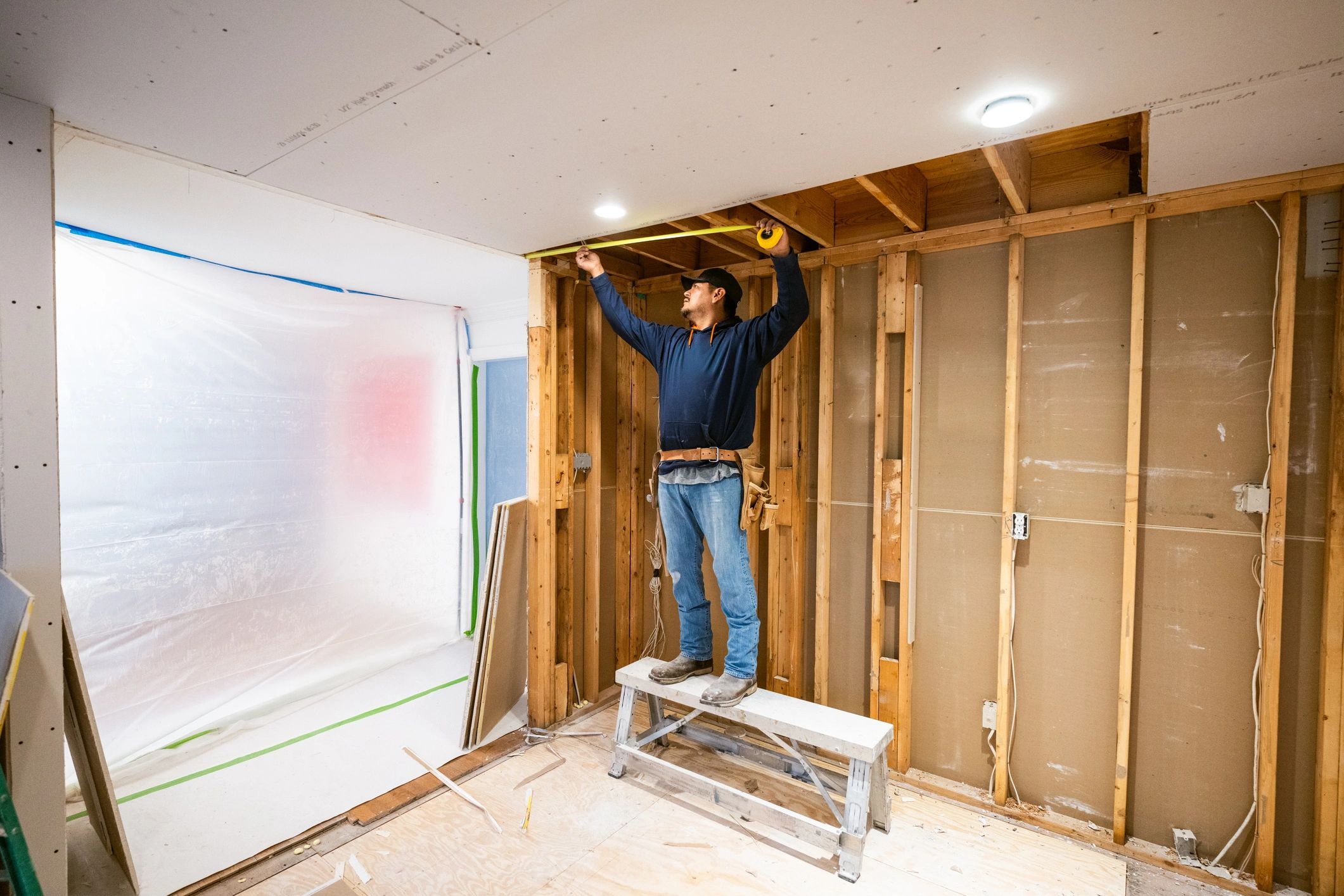 Drywall installers working in kitchen renovation