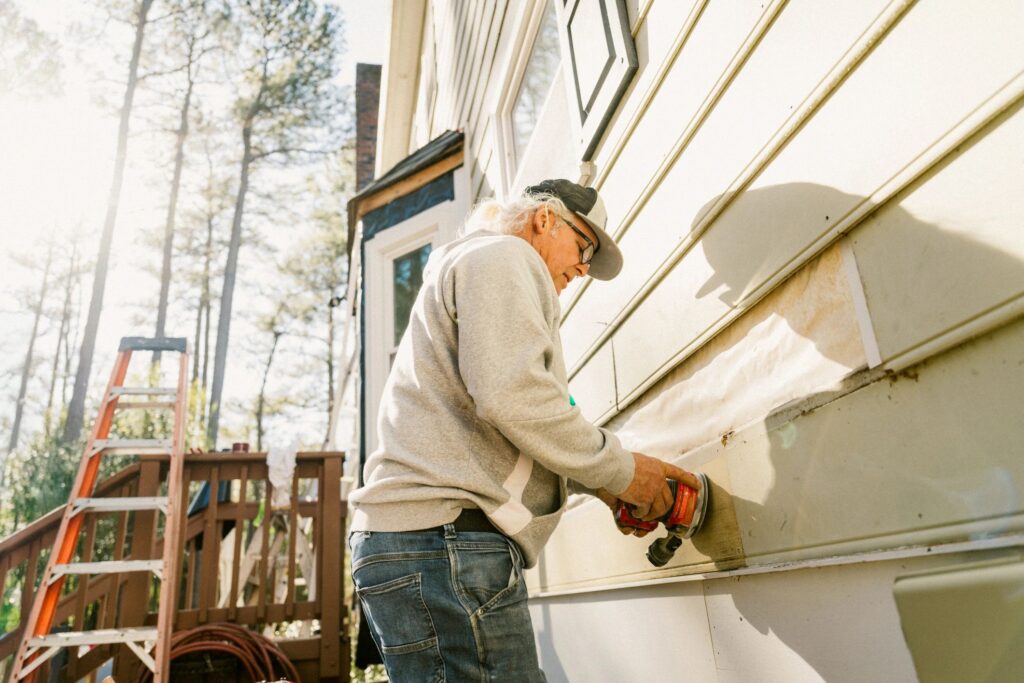 Construction worker repairing a house siding