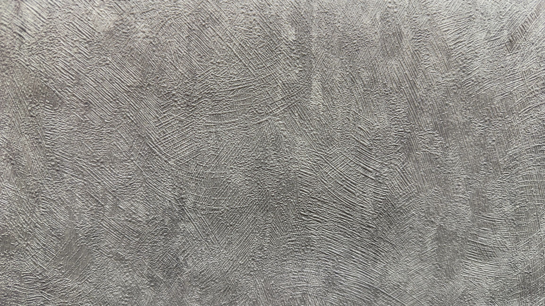 Close-up plaster finish texture showing a smooth professional wall surface