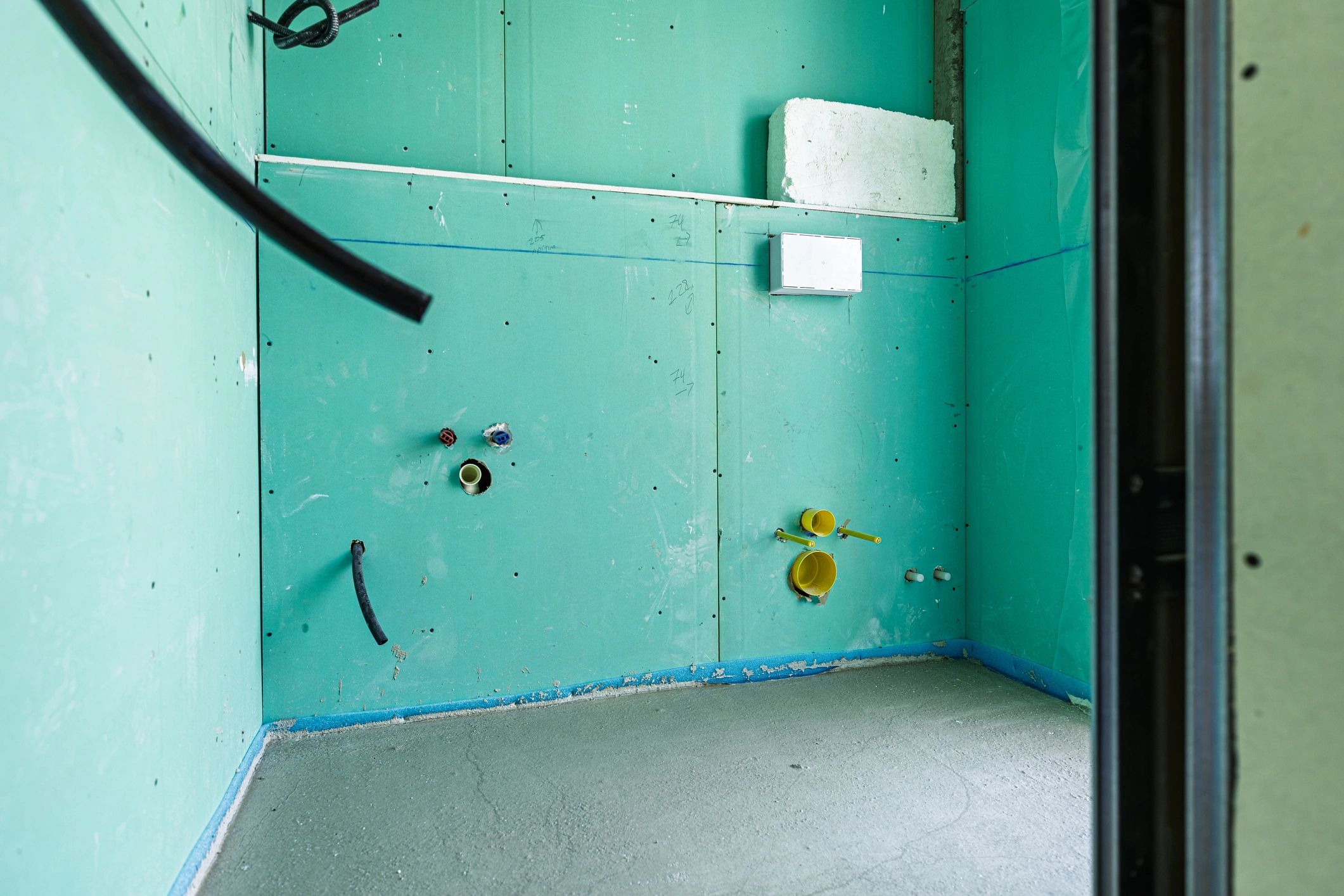 Dry lining installation with plasterboard walls and exposed service runs